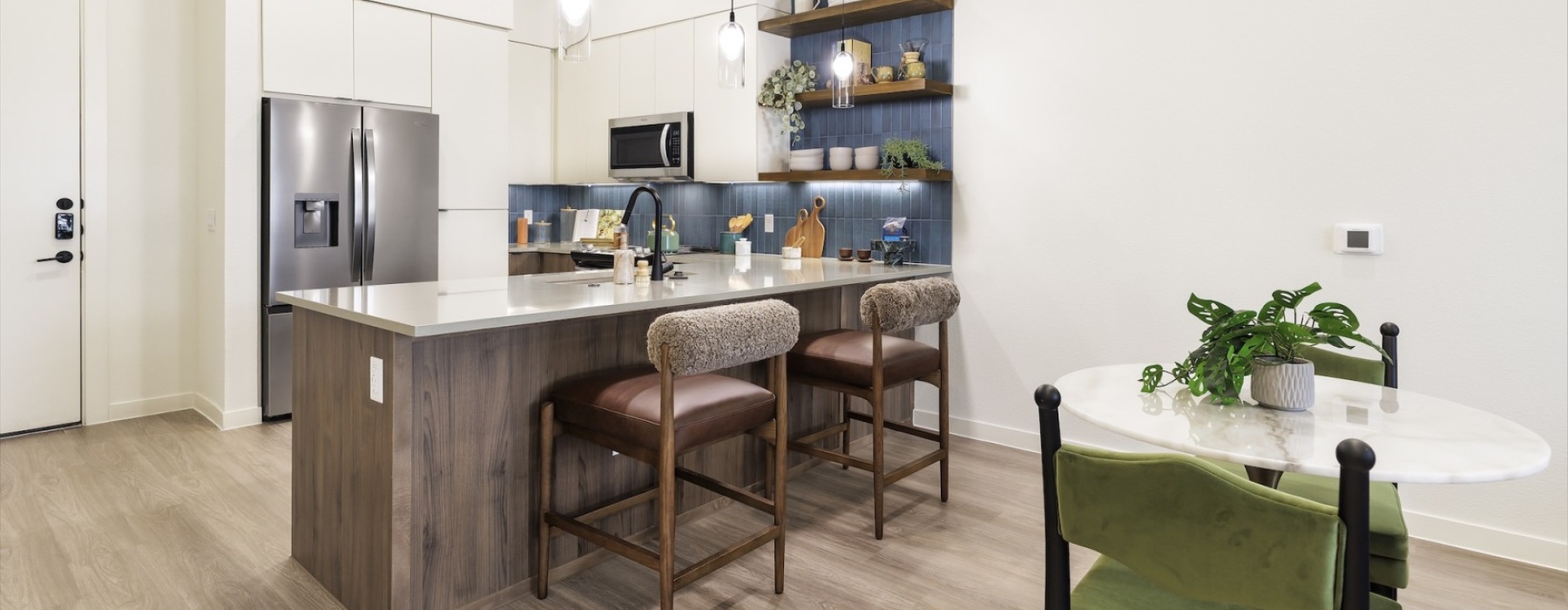 a kitchen with a table and chairs