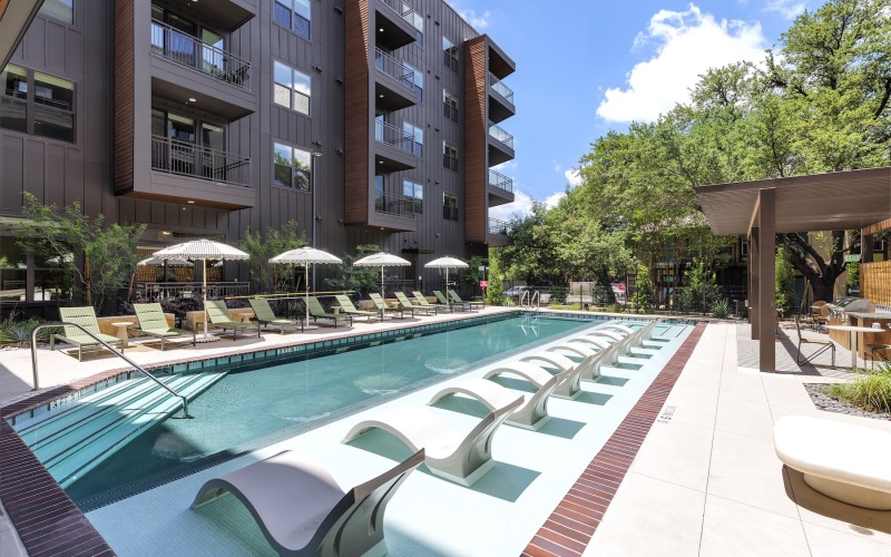 Resort-style swimming pool with lounge seating